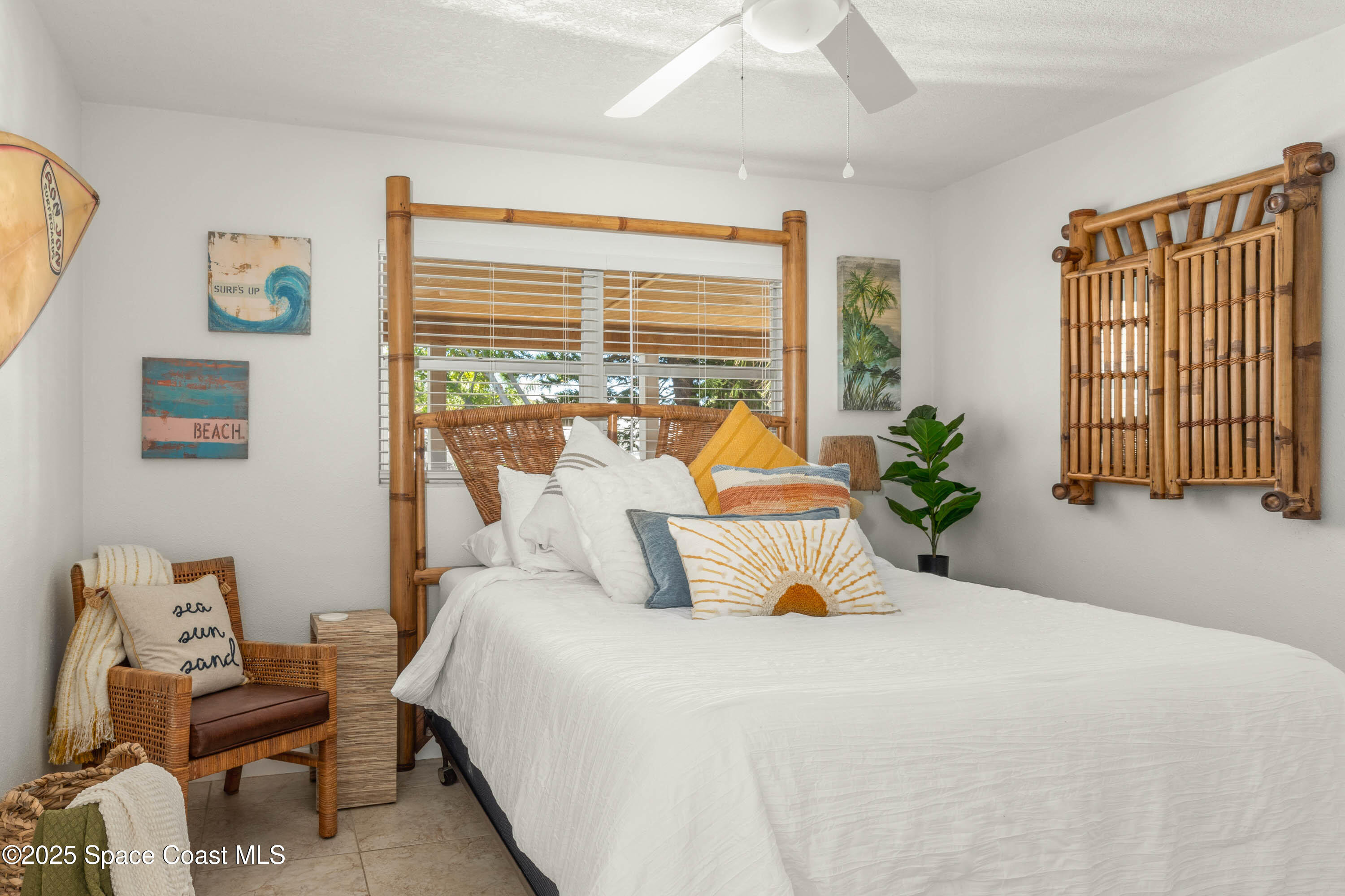124 Aucila Road Cocoa Beach, FL 32931 - Photo 14 of 58 a bedroom with a bed and wooden floor