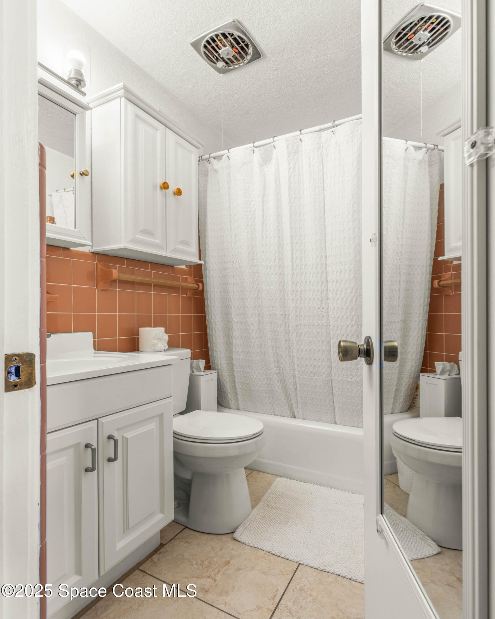 124 Aucila Road Cocoa Beach, FL 32931 - Photo 15 of 58 a bathroom with a sink toilet and shower