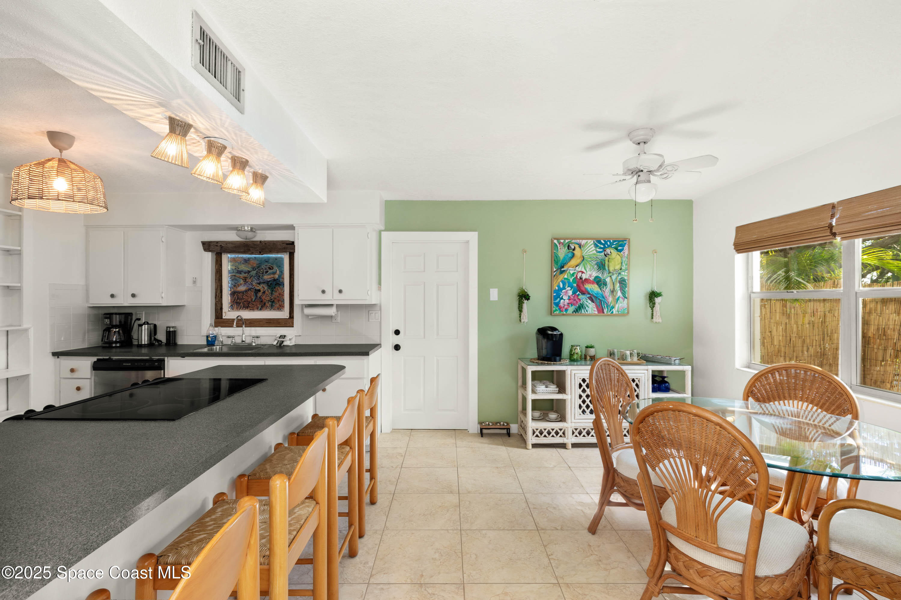124 Aucila Road Cocoa Beach, FL 32931 - Photo 22 of 58 a kitchen with a sink stove and chairs