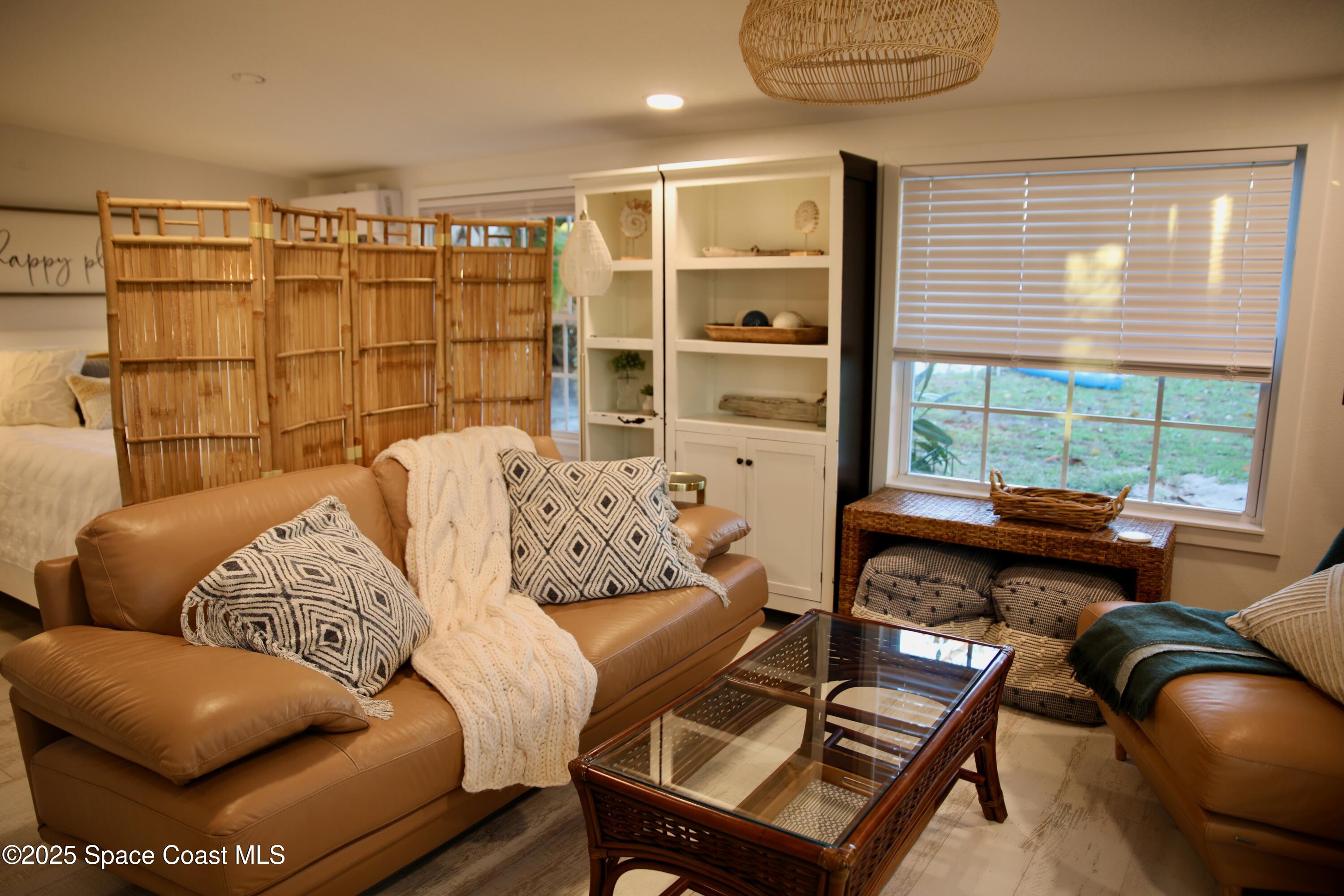 124 Aucila Road Cocoa Beach, FL 32931 - Photo 44 of 58 a living room with furniture and a floor to ceiling window