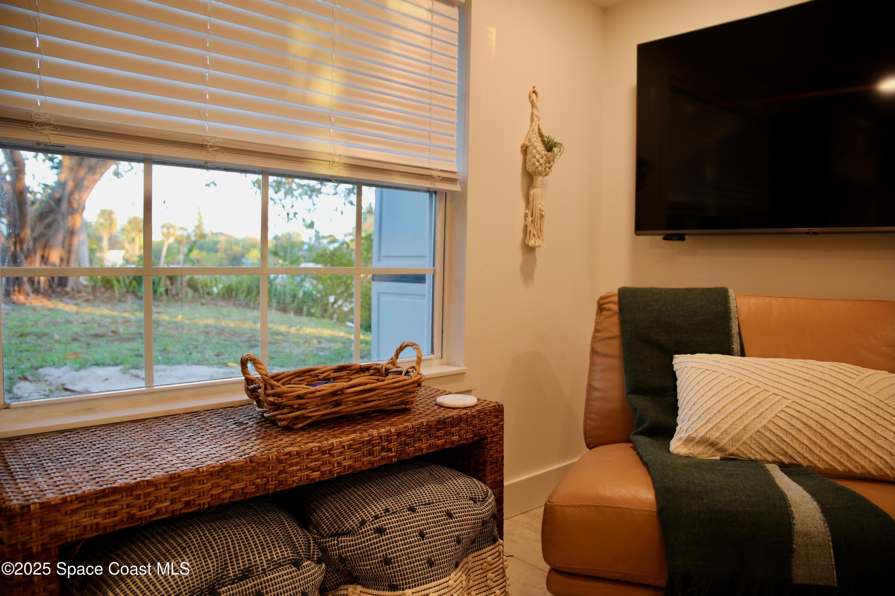124 Aucila Road Cocoa Beach, FL 32931 - Photo 47 of 58 a blue bed sitting in a bedroom next to a window