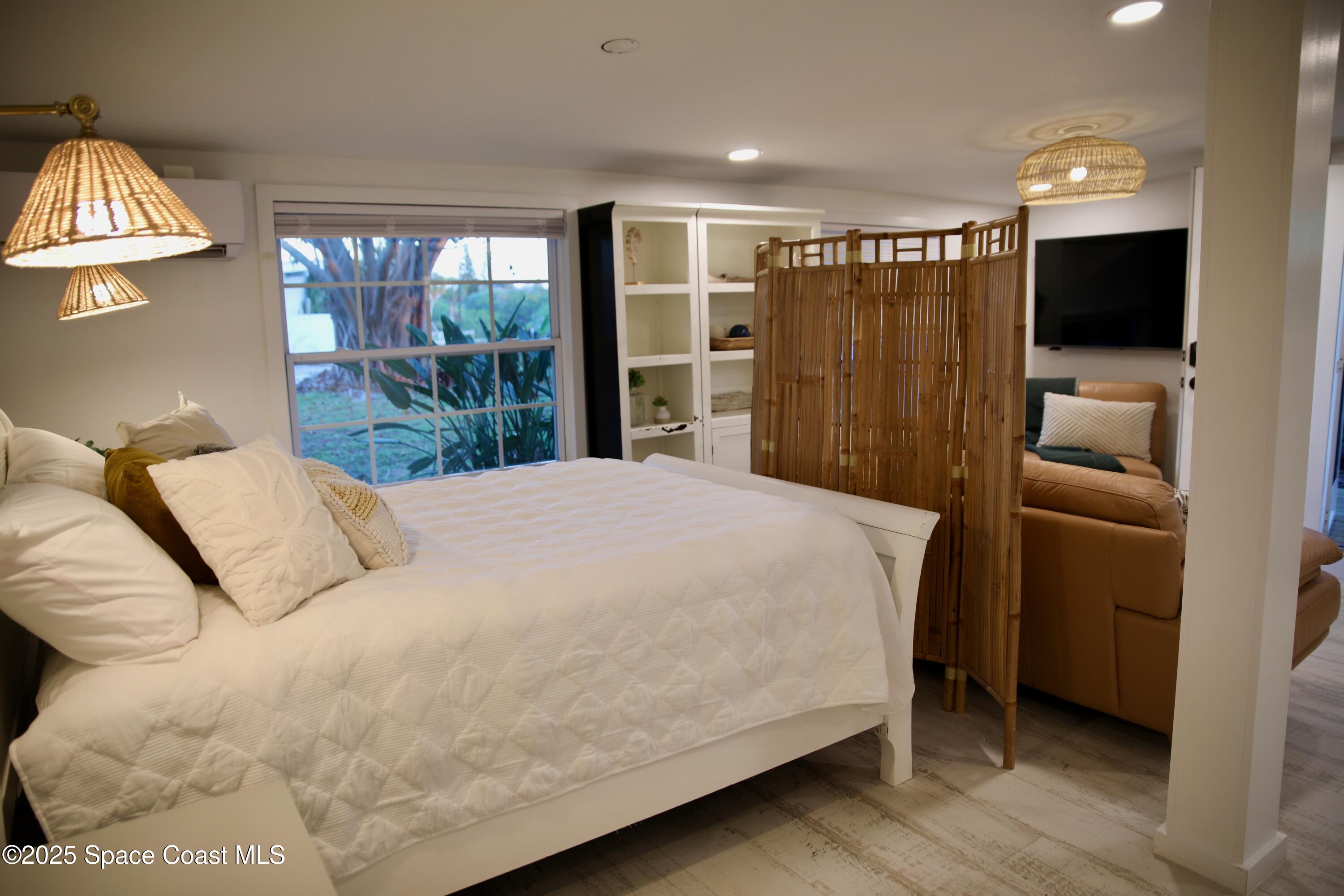 124 Aucila Road Cocoa Beach, FL 32931 - Photo 53 of 58 a large bed sitting in a bedroom next to a window