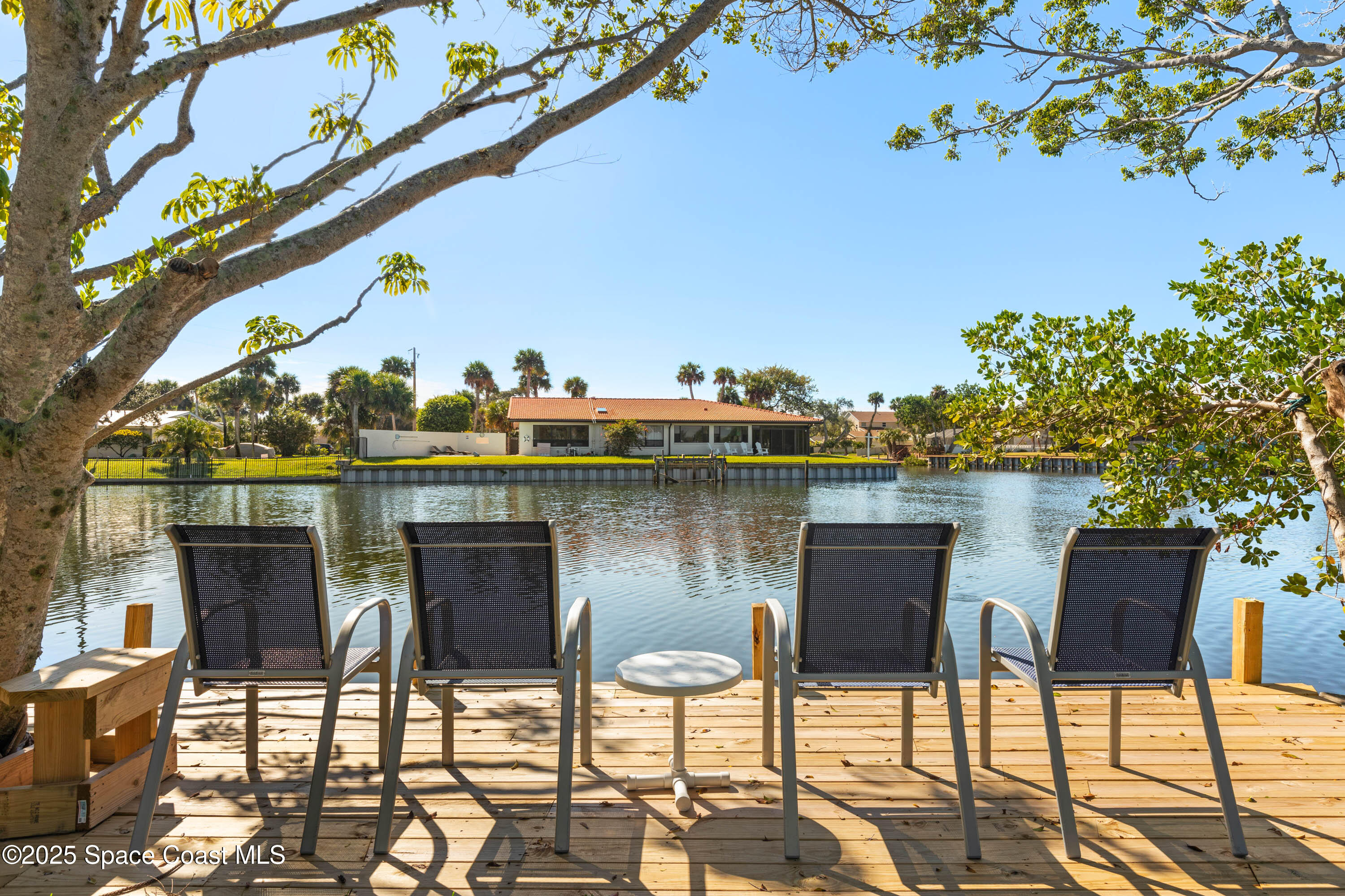 124 Aucila Road Cocoa Beach, FL 32931 - Photo 6 of 58 a table and chairs in front of a yard
