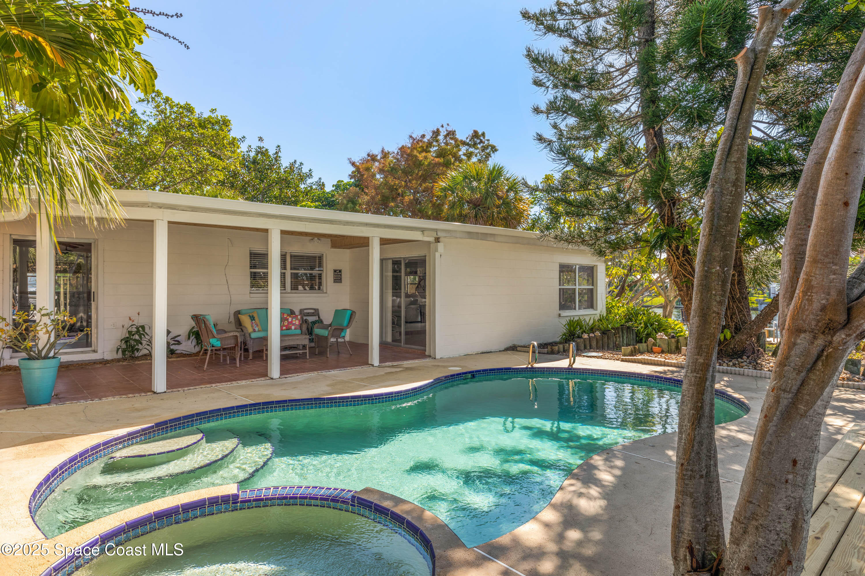 124 Aucila Road Cocoa Beach, FL 32931 - Photo 7 of 58 a backyard of a house with seating space