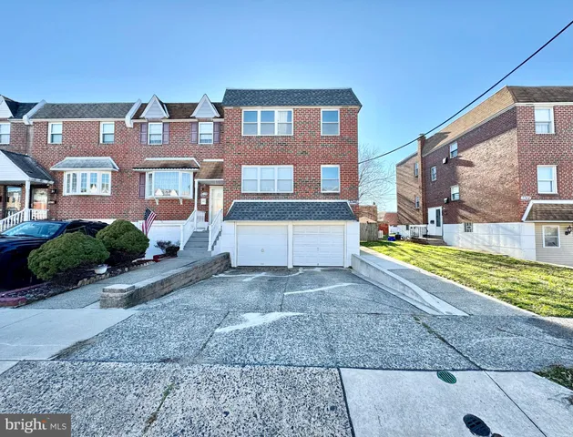 a front view of a house with a yard and outdoor seating