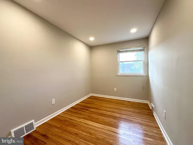 a view of room with wooden floor and fan