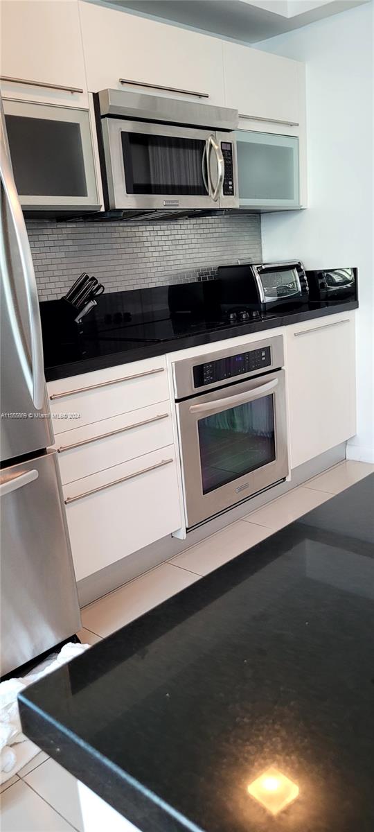 Miami Central Business District Miami, FL 33132 - Photo 8 of 17 a kitchen with granite countertop a stove and a microwave