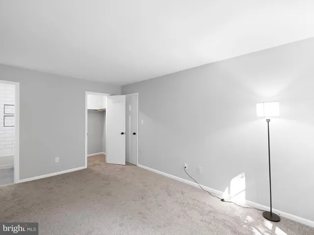 a view of a room with a ceiling fan