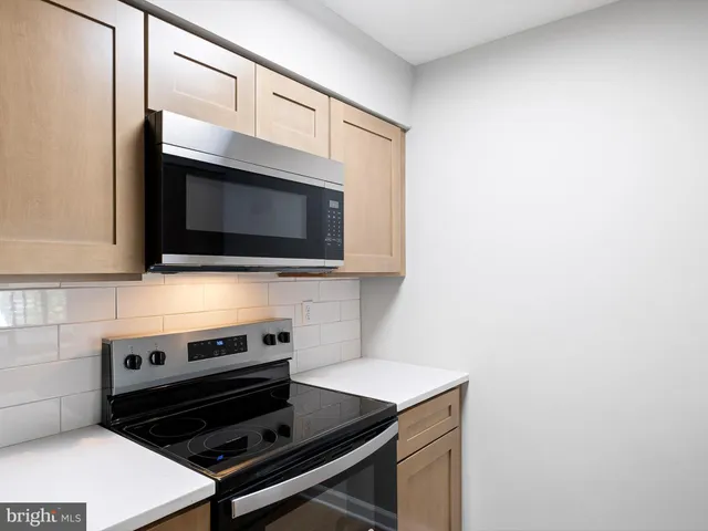 a kitchen with a stove and a microwave