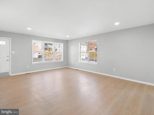 an empty room with windows and closet