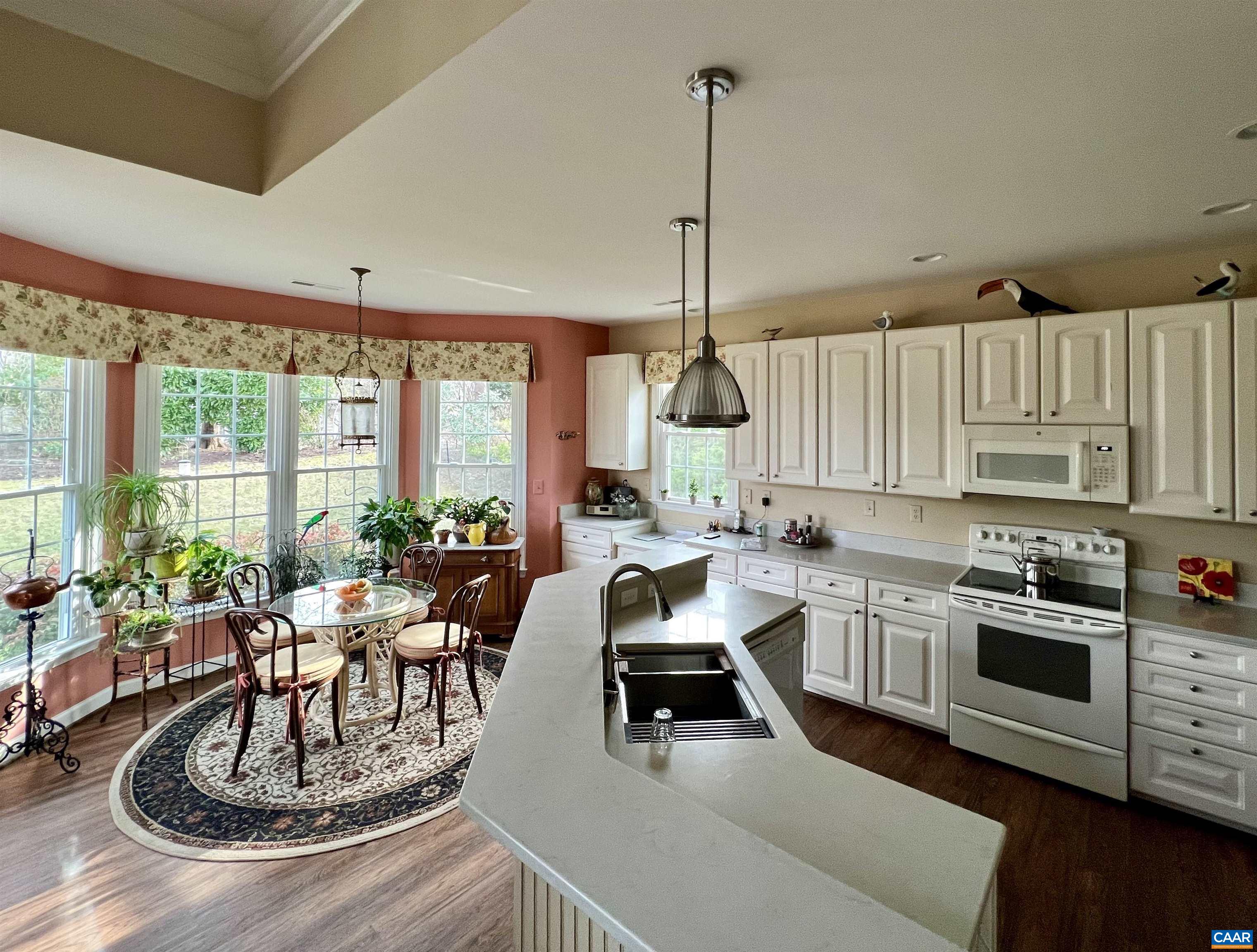 2118 Shepherds Ridge Road Charlottesville, VA 22901 - Photo 15 of 27 a kitchen with kitchen island a large counter top space appliances and a view of living room