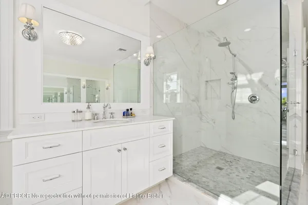 a bathroom with a toilet a sink a mirror and vanity