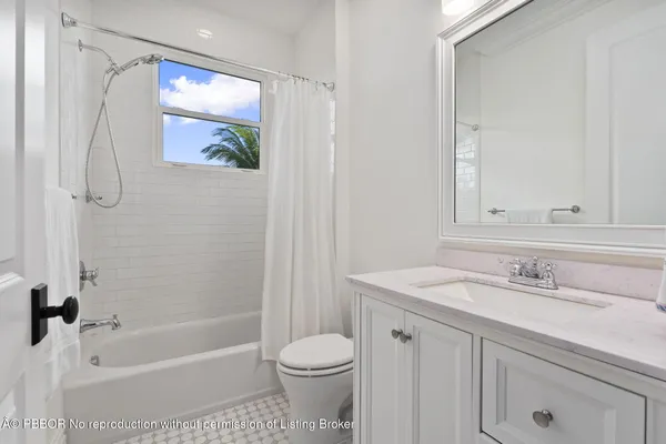 a roof deck with table and chairs under an umbrella