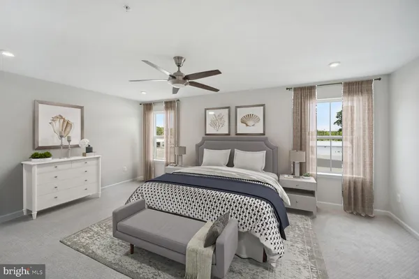 a spacious bedroom with a bed a window and dresser