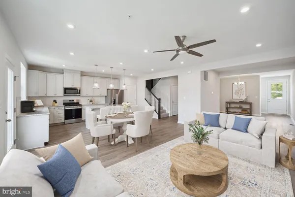 a living room with furniture and kitchen view