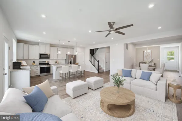 a living room with furniture and kitchen view