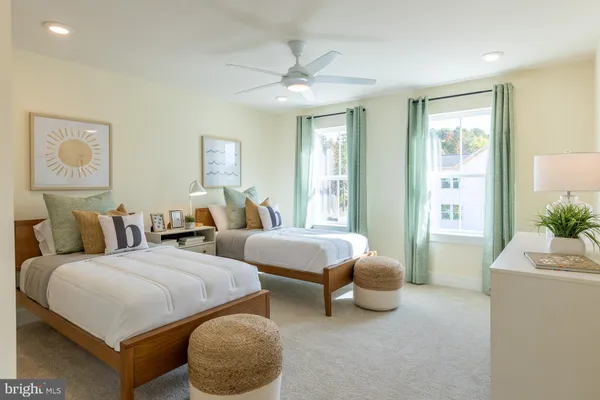 a bedroom with two beds and a large window