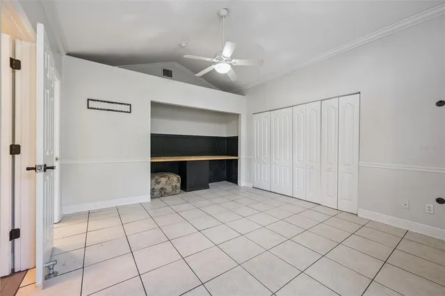 a view of an empty room with wooden shelves