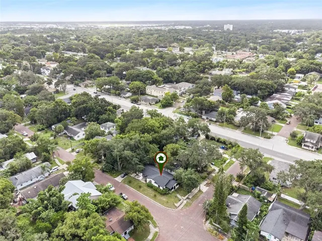 an aerial view of residential houses with outdoor space