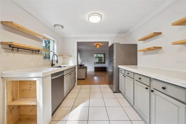 a kitchen with stainless steel appliances granite countertop a sink and cabinets