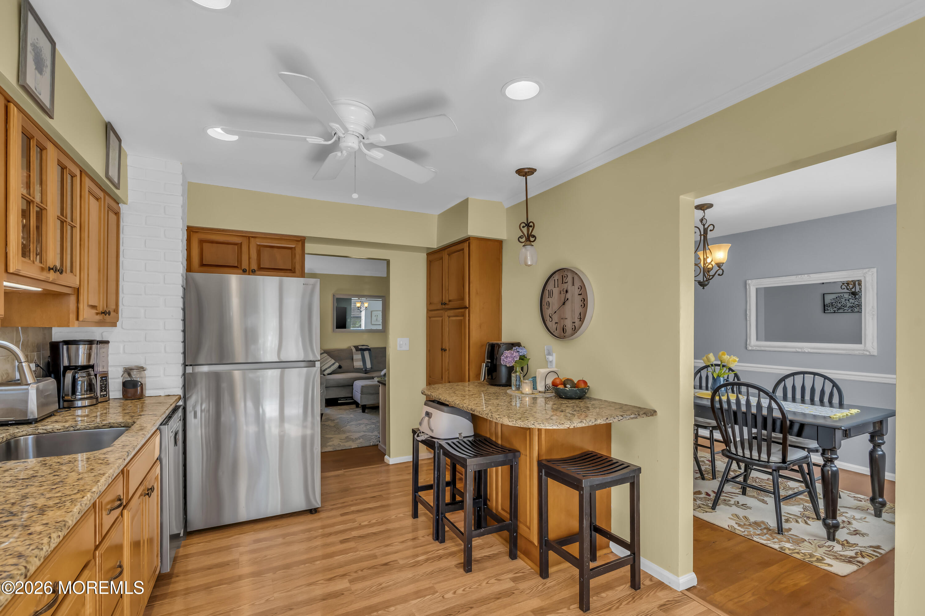 18 Claire Circle Howell, NJ 07731 - Photo 18 of 41 a kitchen with a refrigerator a sink dishwasher a dining table and chairs with wooden floor