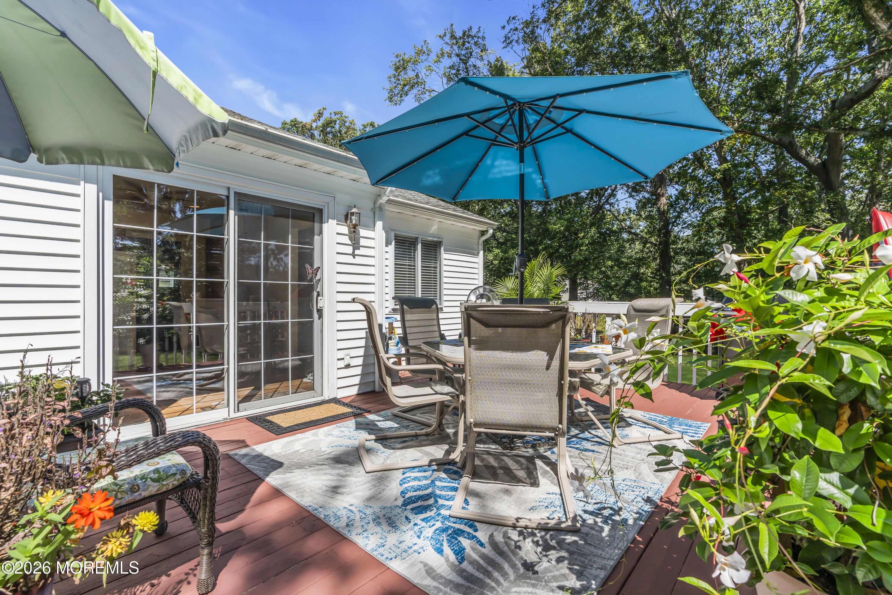 18 Claire Circle Howell, NJ 07731 - Photo 29 of 41 a patio with a table and chairs under an umbrella