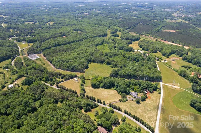 an aerial view of a houses with a yard