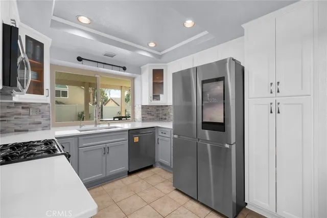a kitchen with granite countertop a stove sink and microwave