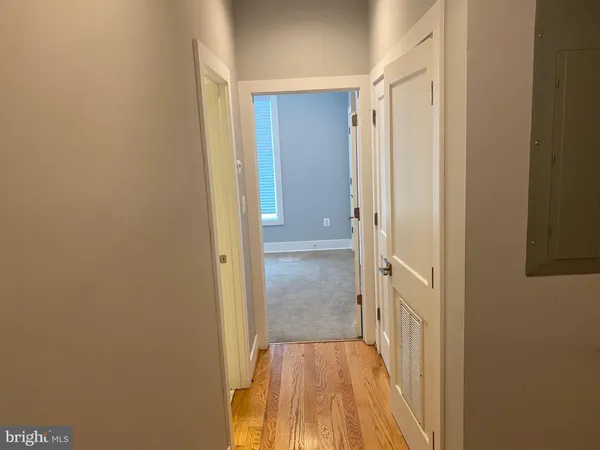 a view of a hallway with wooden floor