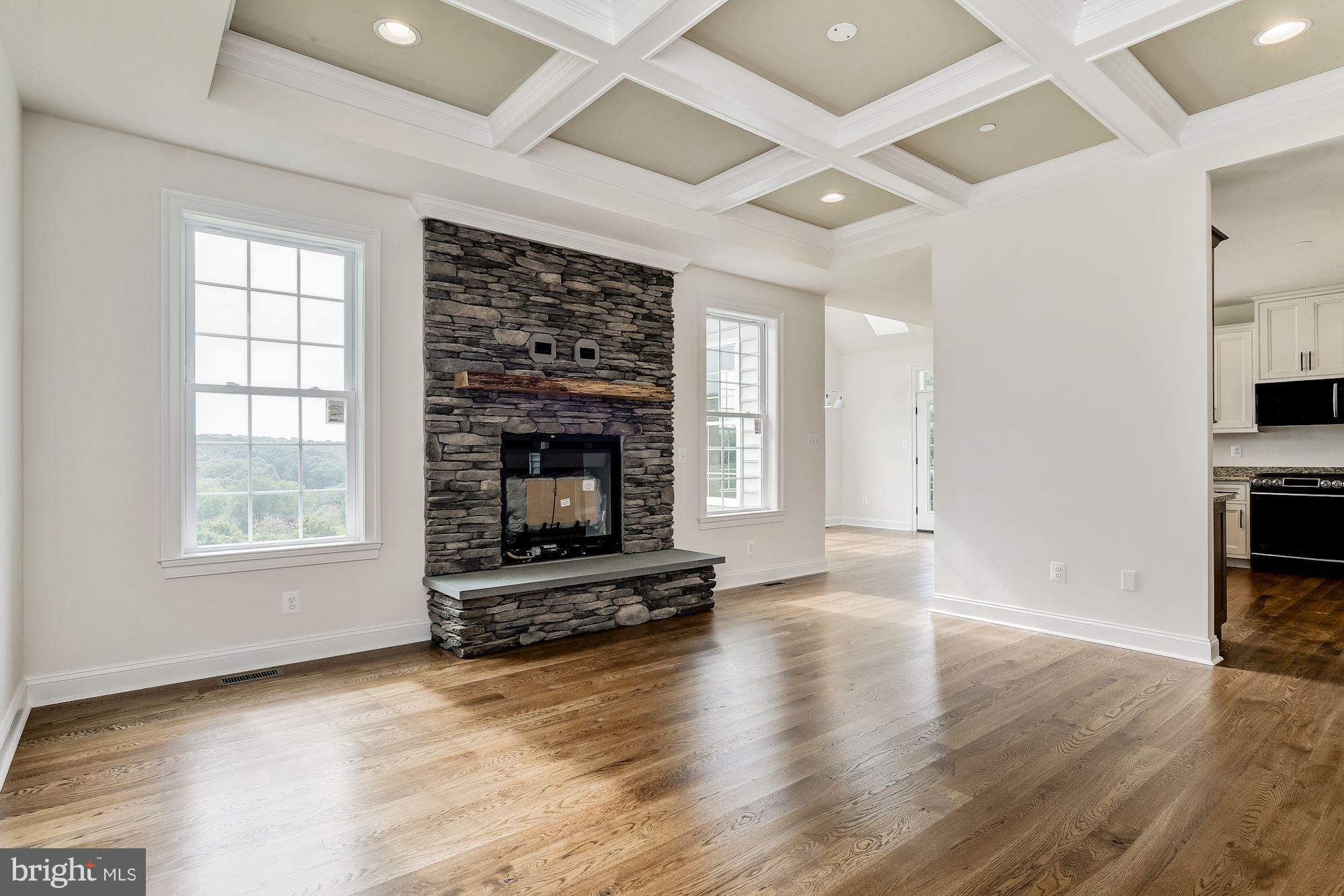 3664 Hooper Road New Windsor, MD 21776 - Photo 3 of 30 wooden floor in an empty room with a fireplace