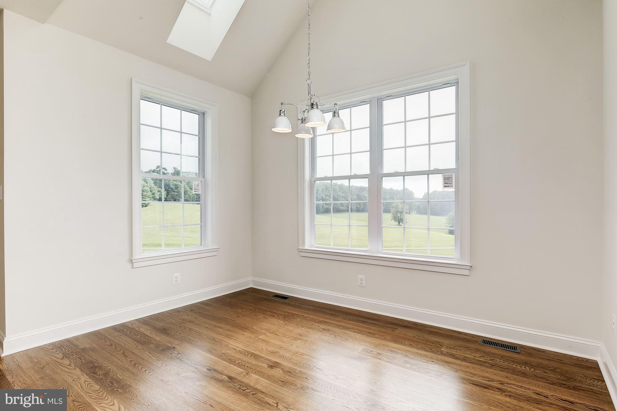 3664 Hooper Road New Windsor, MD 21776 - Photo 9 of 30 an empty room with wooden floor and windows
