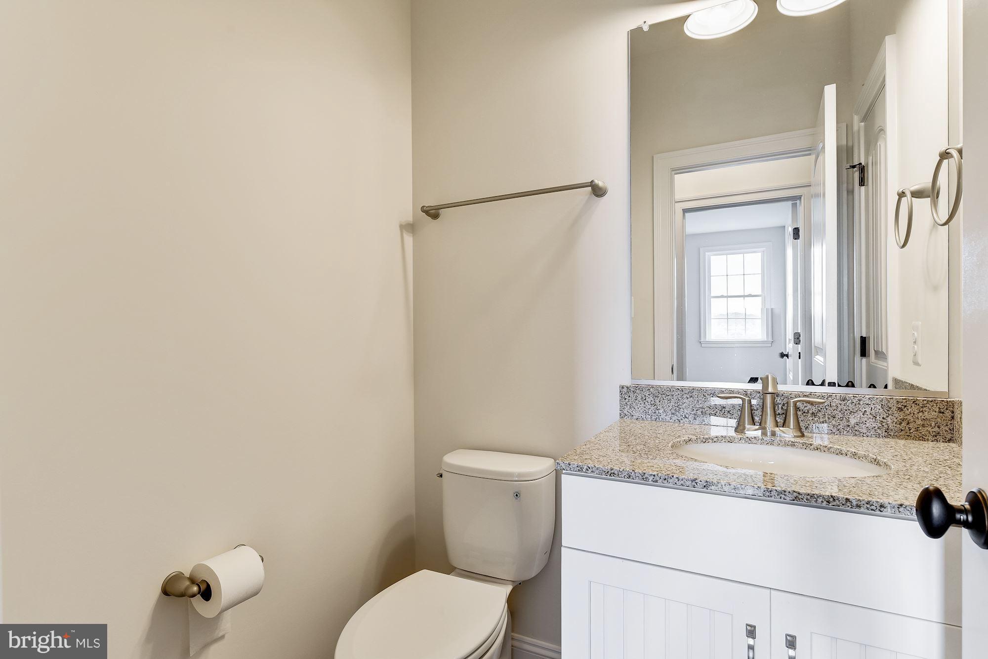 3664 Hooper Road New Windsor, MD 21776 - Photo 10 of 30 a bathroom with a granite countertop sink mirror vanity and toilet