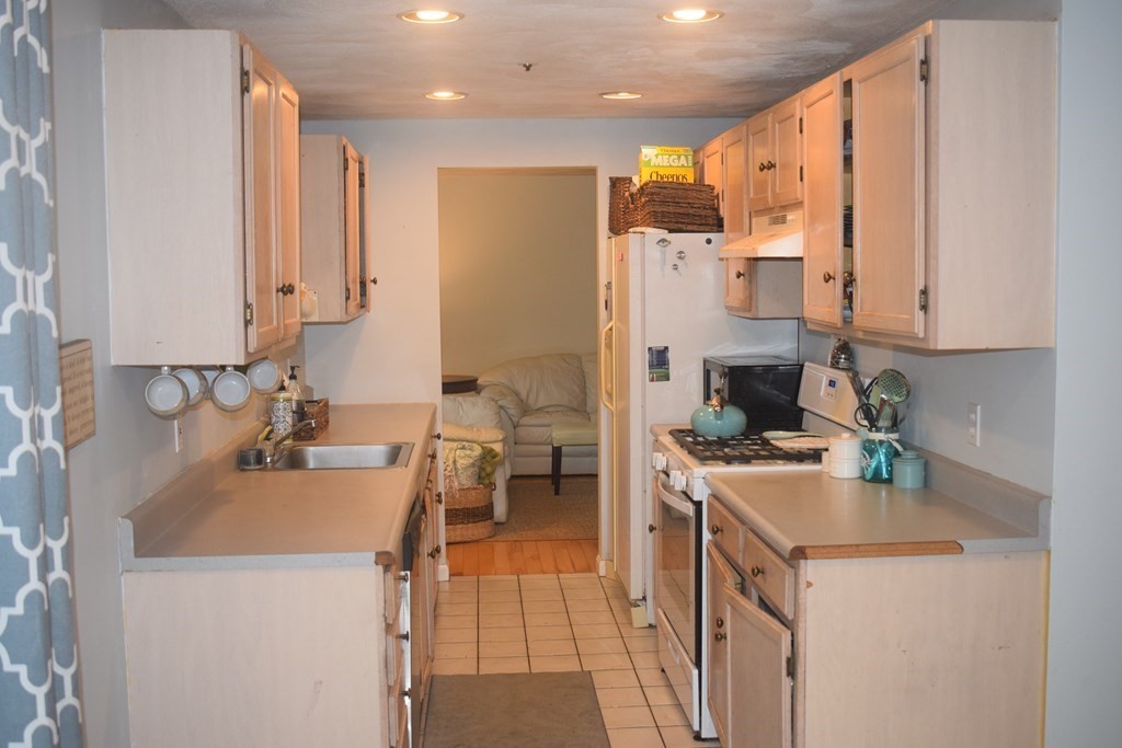 68 Meadowood Road North Andover, MA 01845 - Photo 5 of 40 a kitchen with a sink a stove and a refrigerator