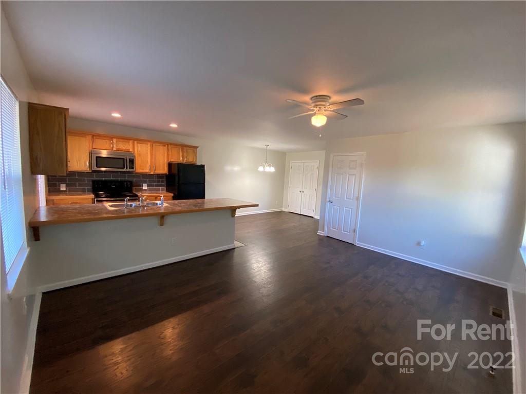 3708 Kelly Road Charlotte, NC 28216 - Photo 2 of 12 a open kitchen with kitchen island a stove and a sink