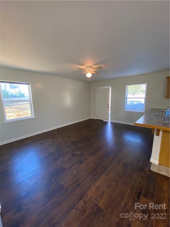 3708 Kelly Road Charlotte, NC 28216 - Photo 3 of 12 a view of an empty room with wooden floor and a window