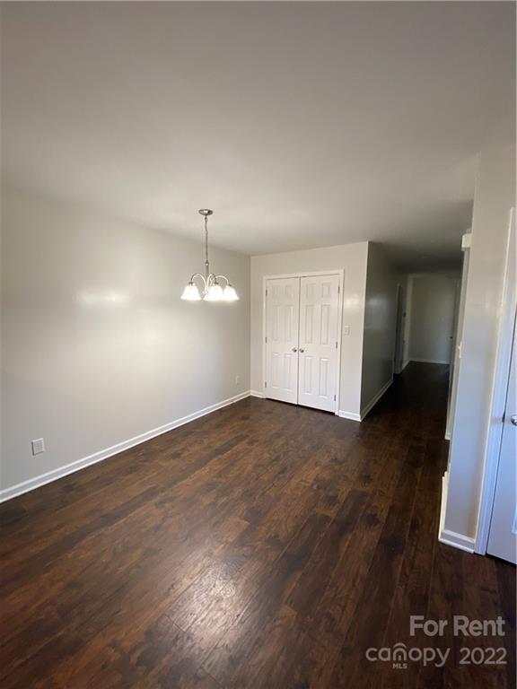 3708 Kelly Road Charlotte, NC 28216 - Photo 5 of 12 an empty room with wooden floor and window