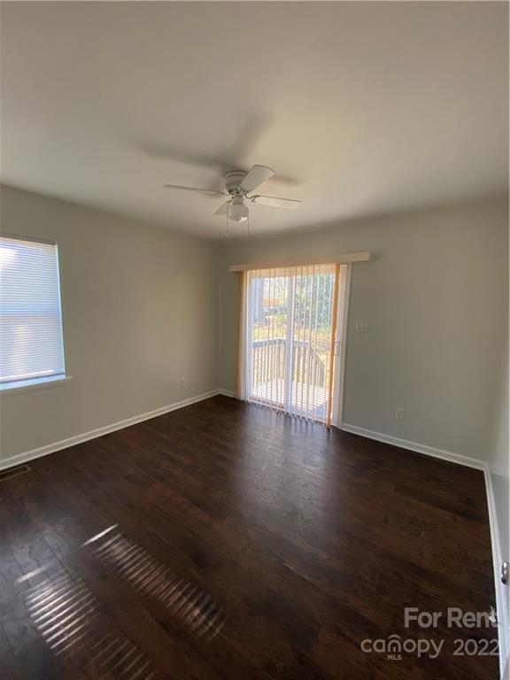 3708 Kelly Road Charlotte, NC 28216 - Photo 9 of 12 a view of an empty room with wooden floor and a window