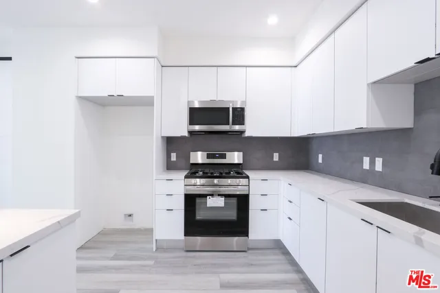 a kitchen with a stove and a microwave