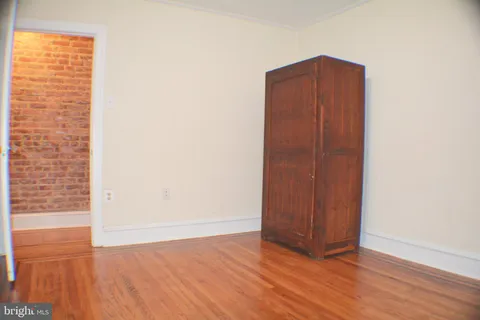 a view of wooden floor and windows in a room