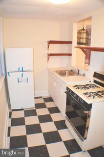 a kitchen with a checkered floor and a stove