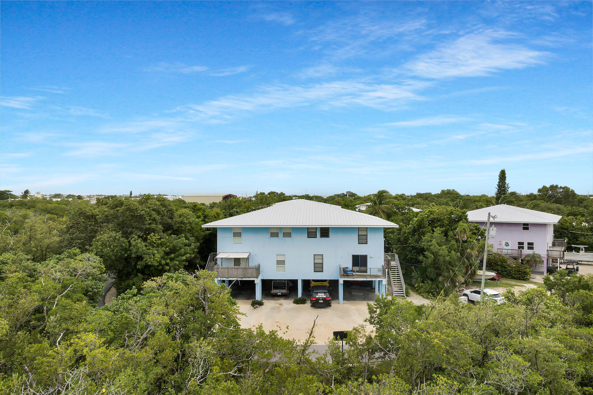 an aerial view of a house with swimming pool and mountains