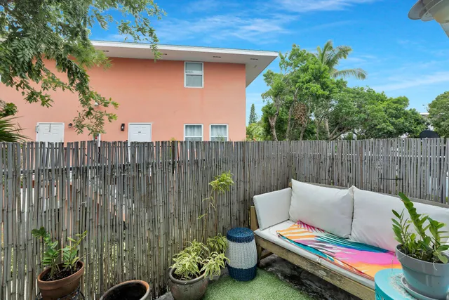a backyard of a house with table and chairs