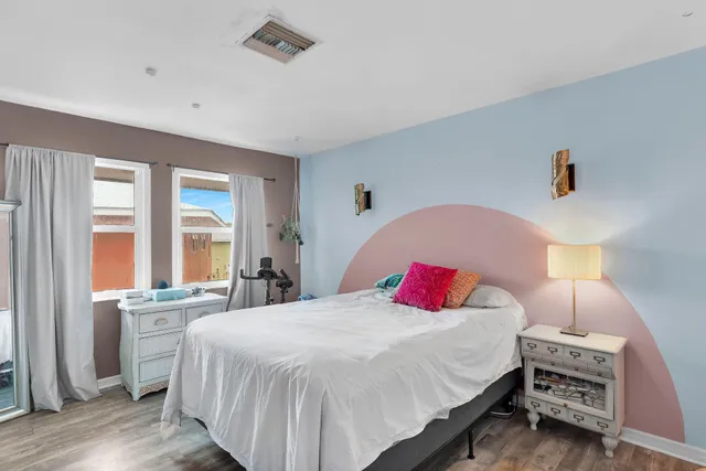 a bedroom with a bed and a window