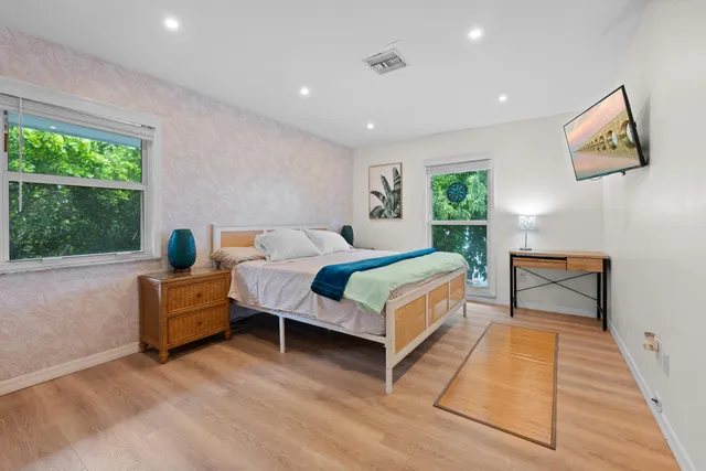 a bedroom with a bed and window