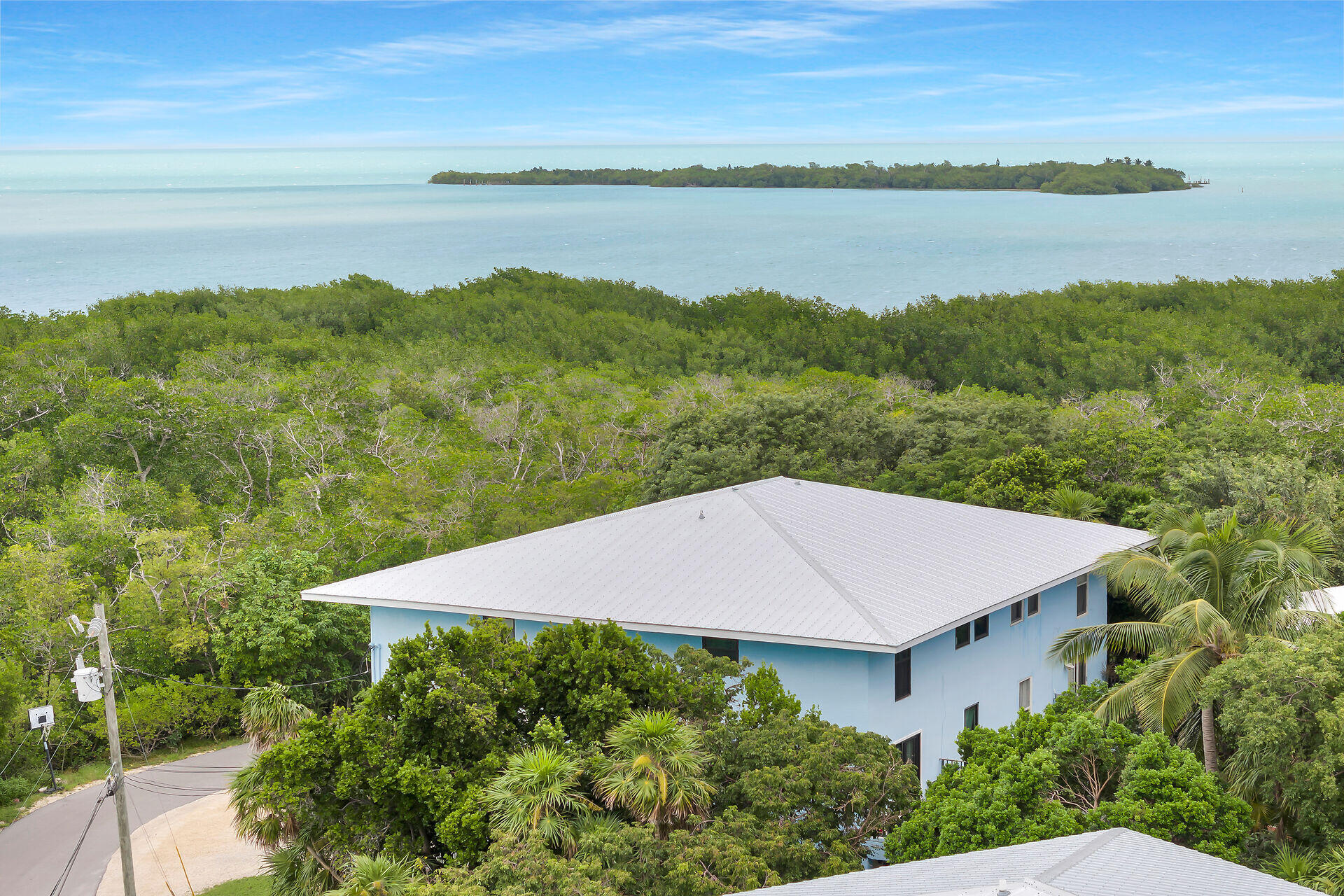 113 Stirrup Key Woods Road, Unit 3B1 Marathon, FL 33050 - Photo 2 of 21 a view of a lake with a mountain in the background