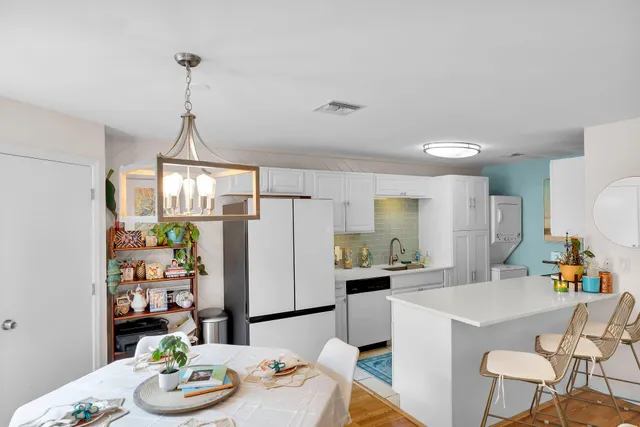 a kitchen with stainless steel appliances a dining table and chairs