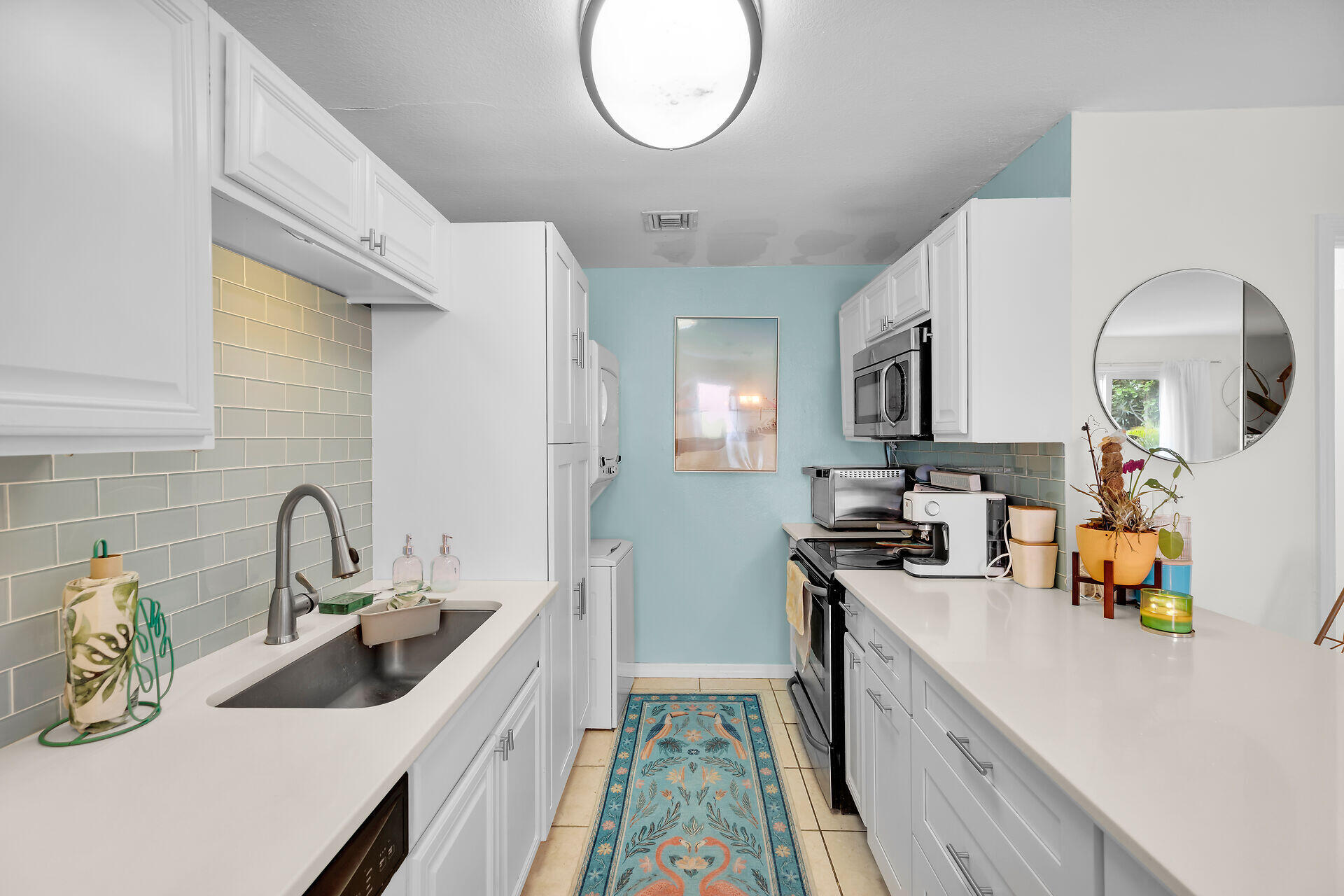 113 Stirrup Key Woods Road, Unit 3B1 Marathon, FL 33050 - Photo 9 of 21 a kitchen with a sink a stove and cabinets