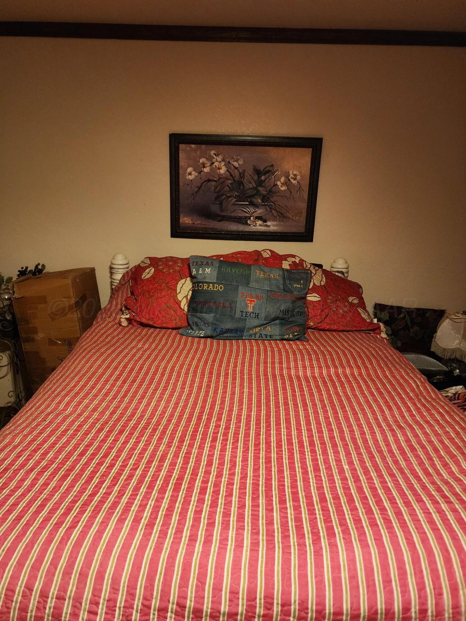 16700 Old Ranch Road Canyon, TX 79015 - Photo 29 of 54 a bedroom with a bed and a painting on the wall