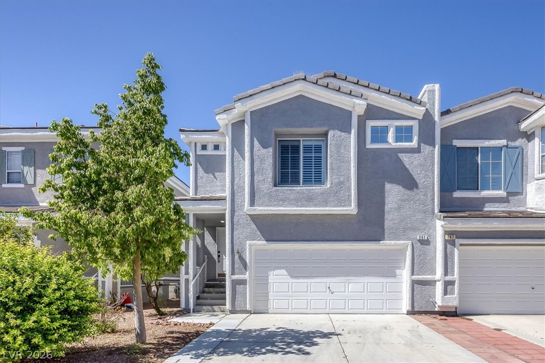 251 Integrity Ridge Drive Henderson, NV 89052 - Photo 26 of 32 A modern multi-level exterior displays structured stucco walls and an integrated multi-car garage.