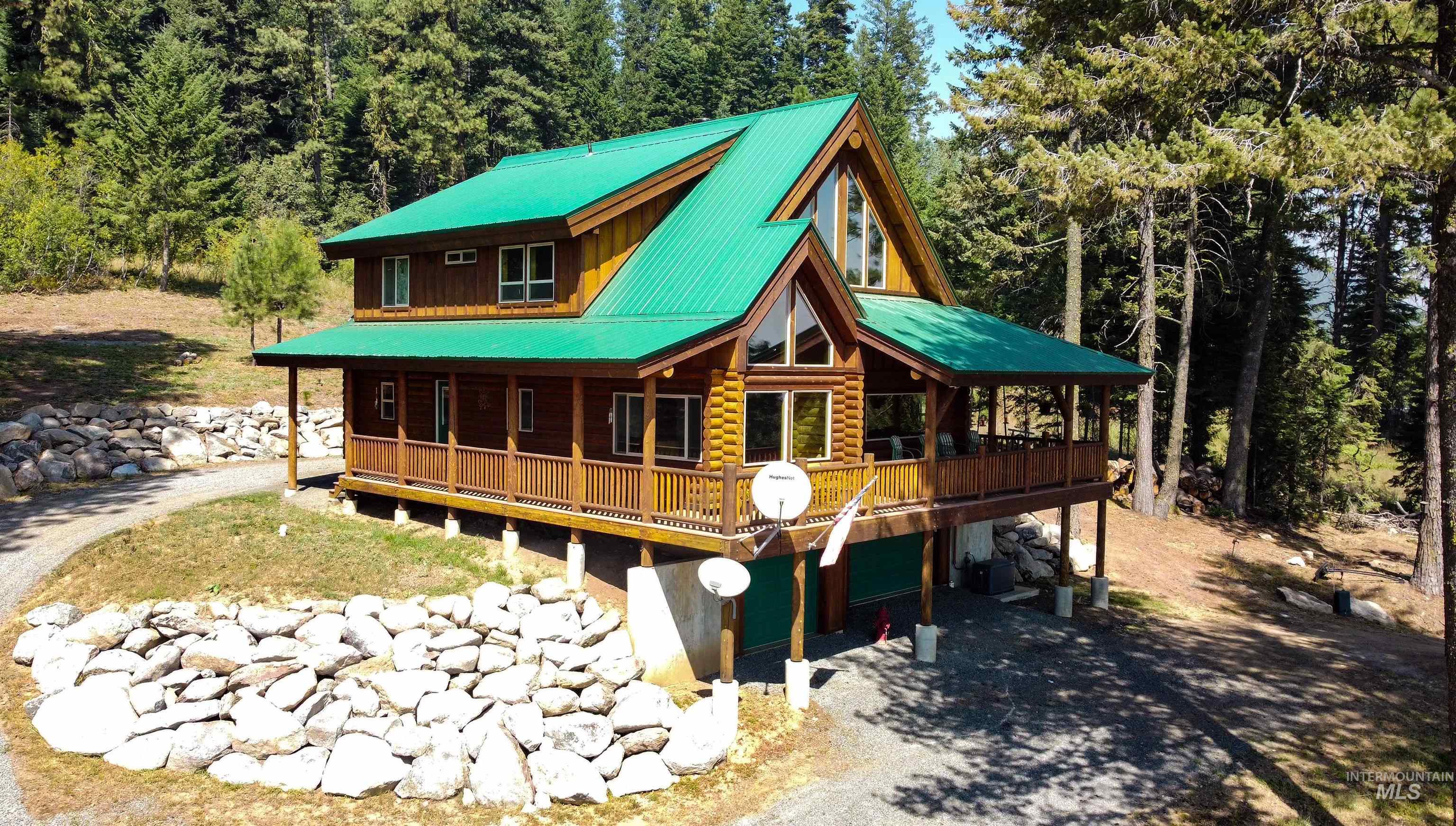 1539 West Mountain Road Cascade, ID 83611 - Photo 28 of 33 Rear view of property with a porch, driveway, an attached garage, and a metal roof
